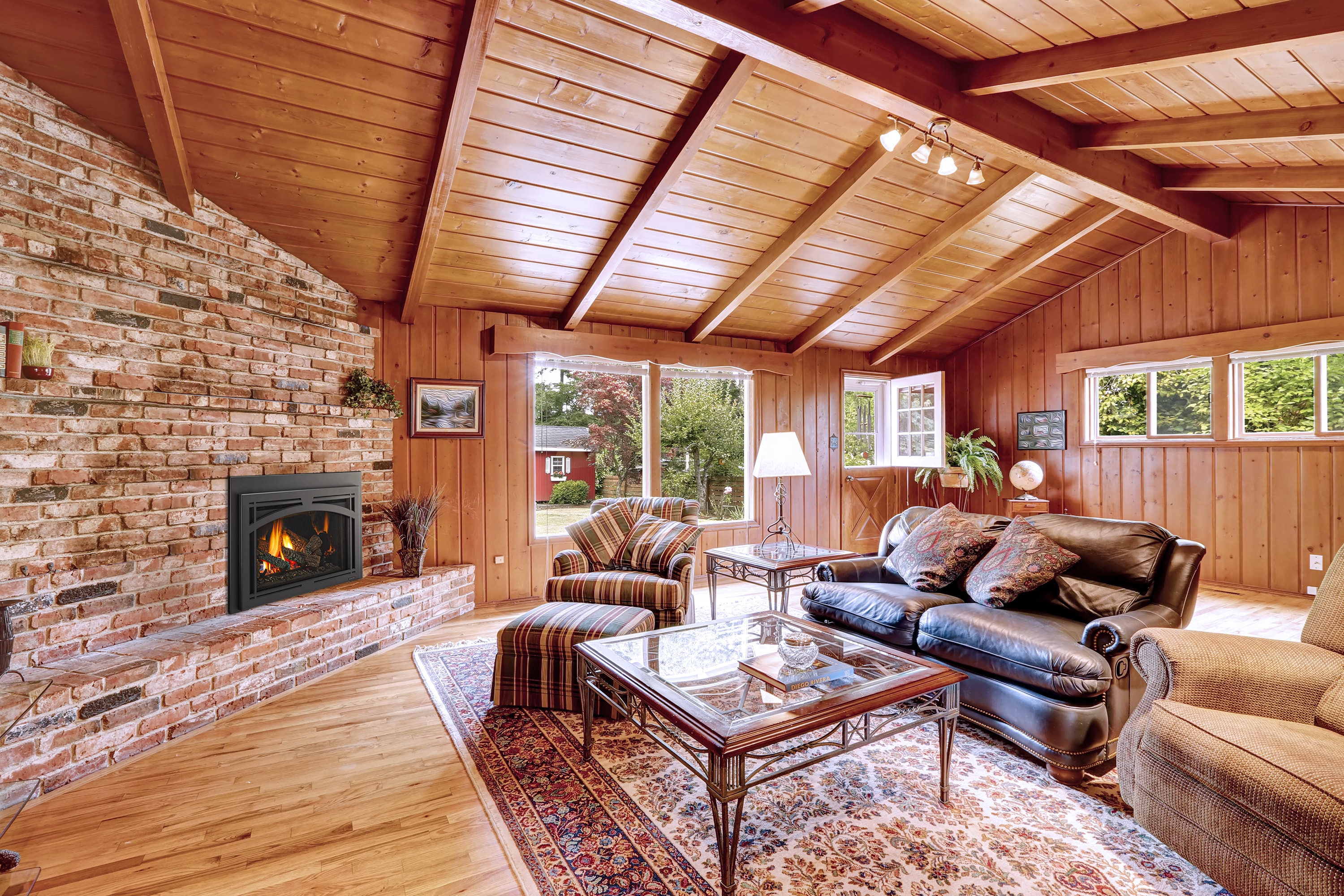 Majestic Trilliant 30 Tuscan Arch gas fireplace in wood-paneled traditional room